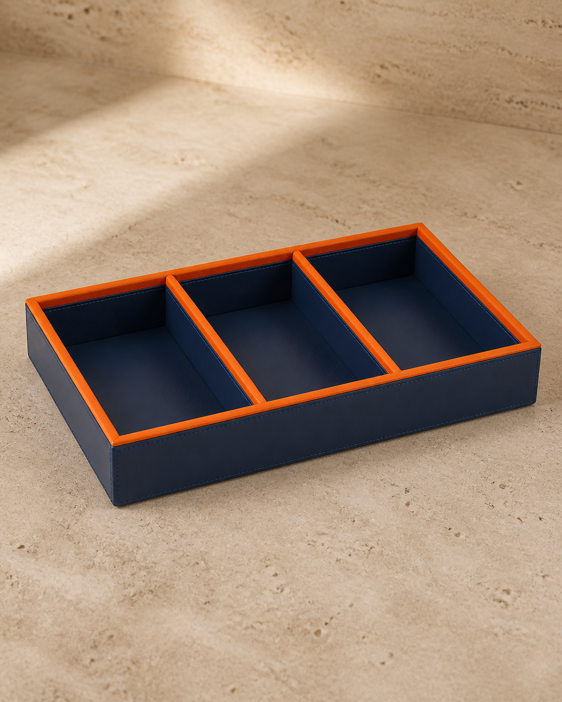 Blue compartment tray with orange piping, 3 compartments, grounded editorial view