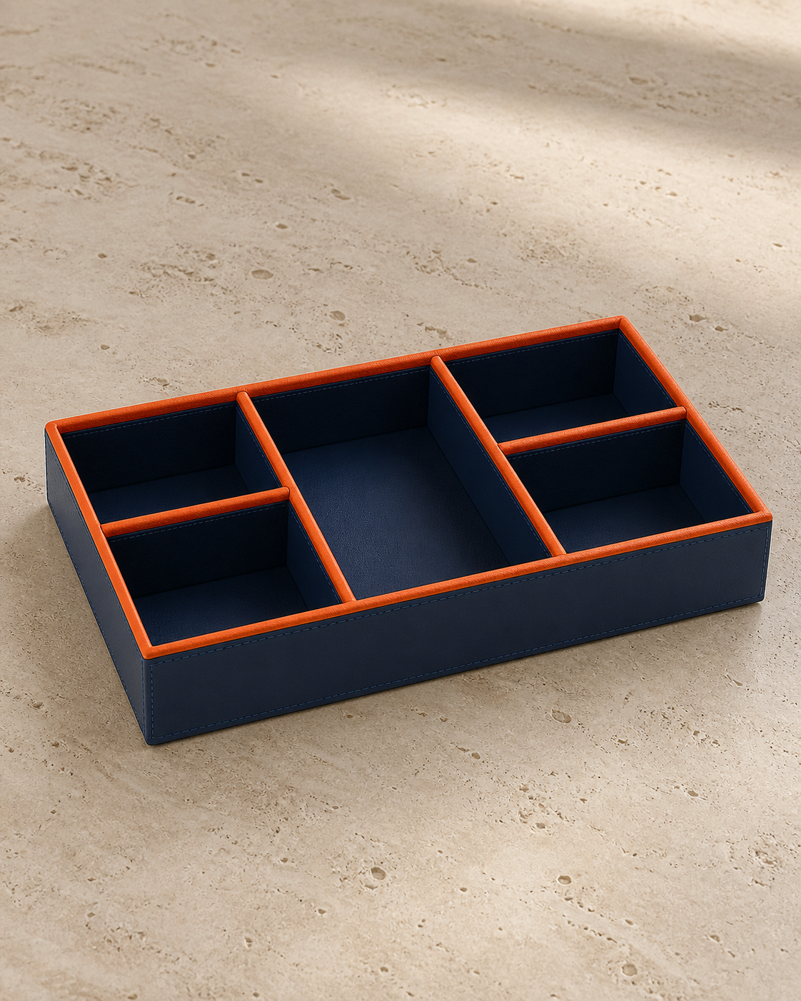 Blue compartment tray with orange piping, 5 compartments, grounded editorial view