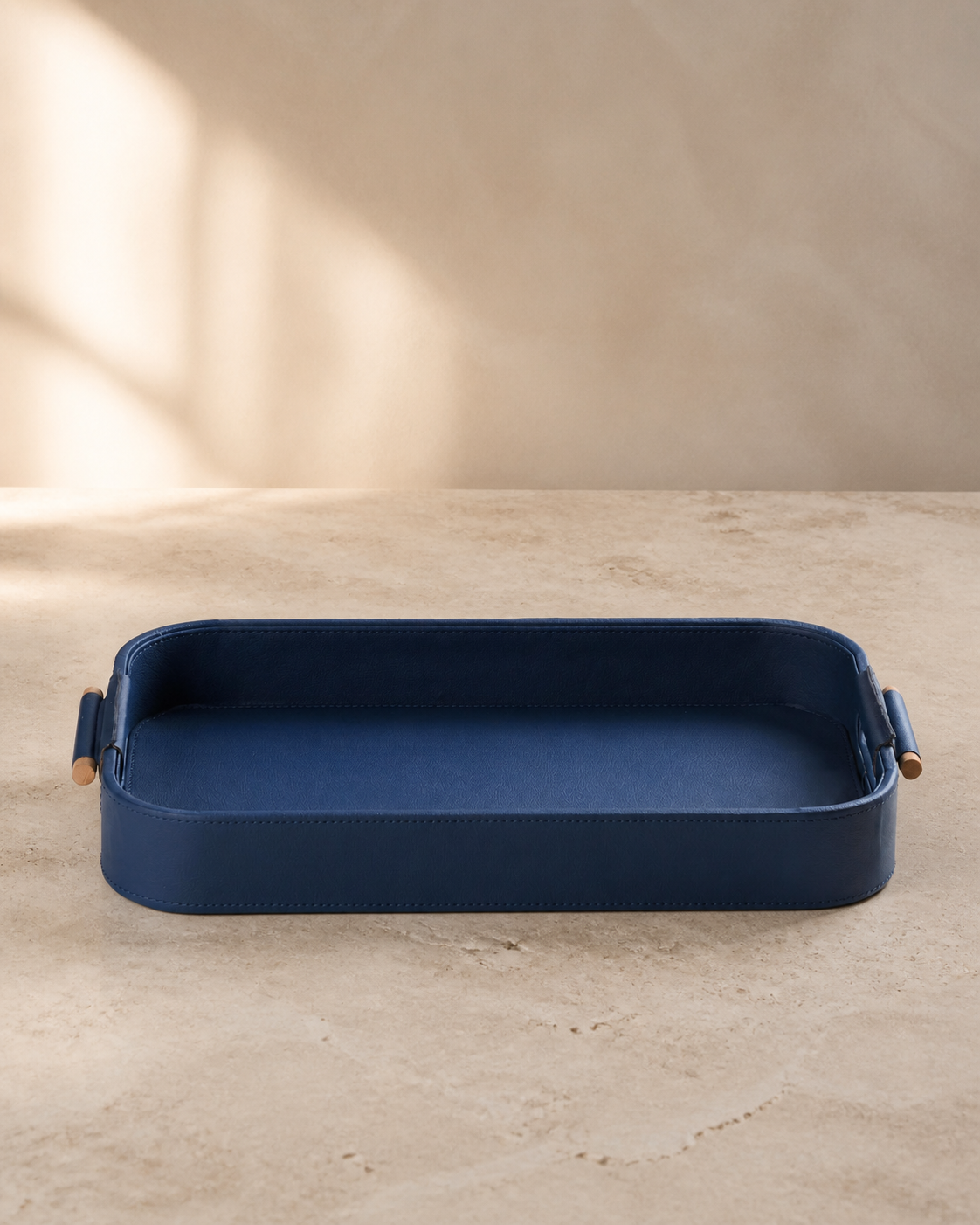 Blue serving tray with wooden handles, grounded editorial product view