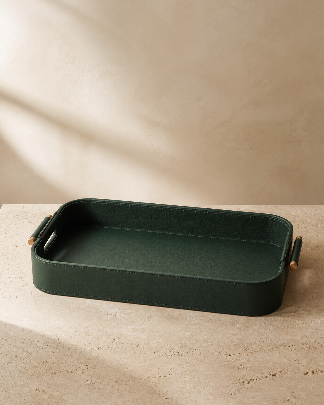 Green serving tray with wooden handles, grounded editorial product view