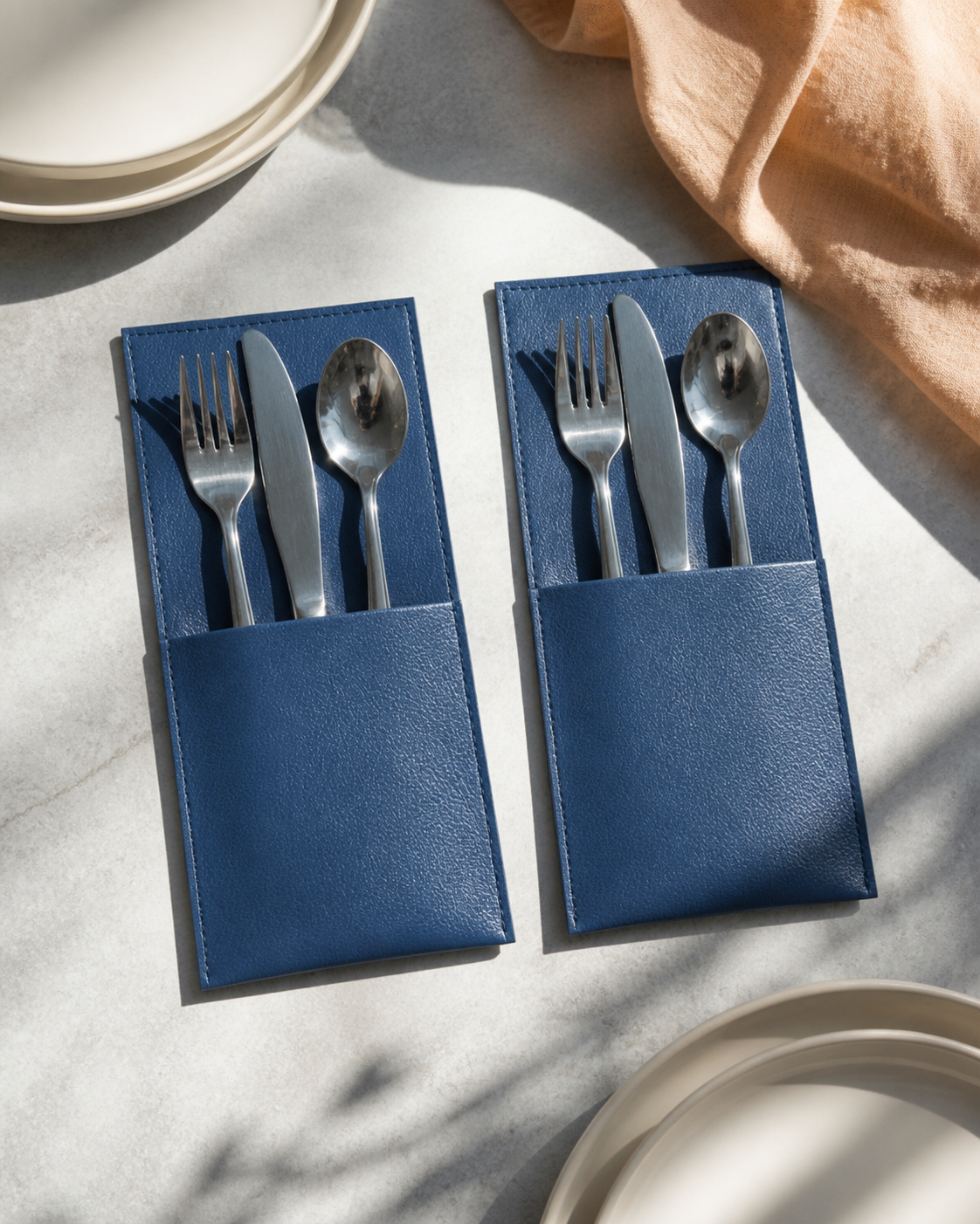 Blue faux-leather cutlery holders in editorial place settings